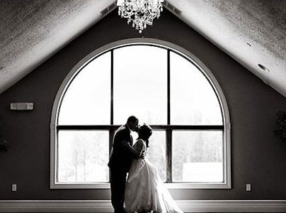 Bride and groom kissing at wedding ceremony.